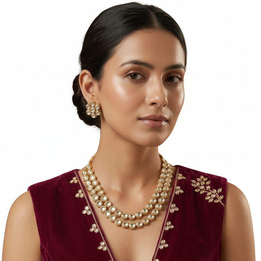 Woman wearing EVAH JEWELS traditional gold-tone double-layer white Kundan necklace set with matching floral cluster stud earrings and a burgundy embroidered ethnic outfit.