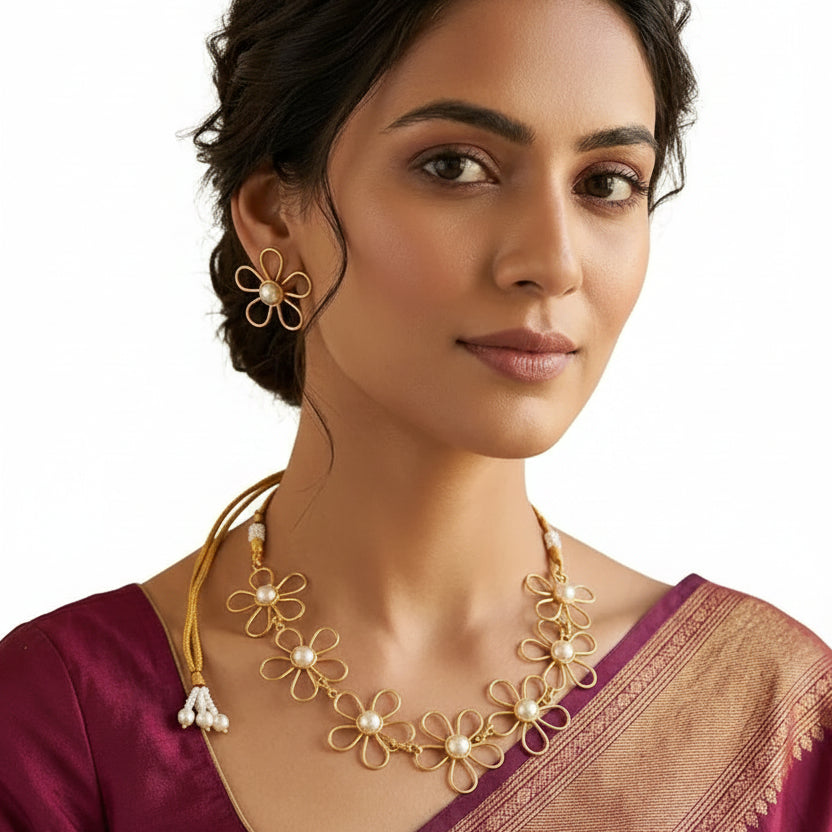 Woman wearing EVAH JEWELS gold-tone floral pearl necklace and matching daisy flower earrings with a traditional saree, showcasing elegant fashion jewellery for women.