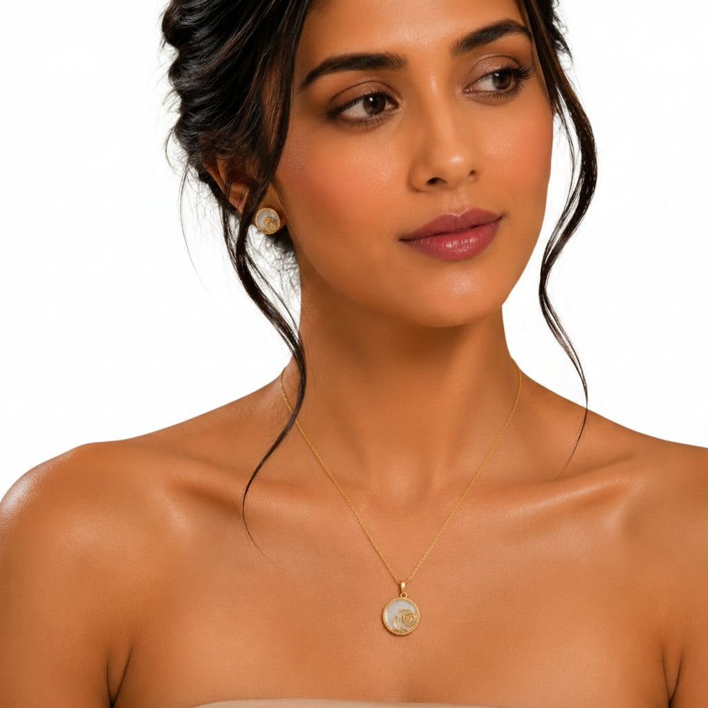 Woman wearing EVAH JEWELS gold-tone floral pendant necklace and matching round stud earrings with white detailing, rose design and sparkling accents.