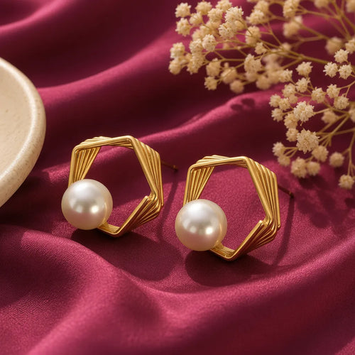 gold-tone geometric hexagon pearl stud earrings for women, featuring layered open-frame designs and elegant white pearl accents on burgundy satin by Evah Jewels.
