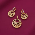 gold-tone geometric circular pendant and matching crystal-studded hoop drop earrings featuring an intricate openwork starburst design on burgundy fabric by Evah Jewels.