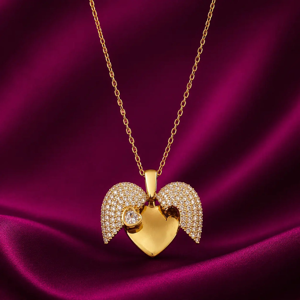 Gold-tone imitation jewellery necklace with a heart-shaped pendant, sparkling wing details, and a heart accent by Evah Jewels