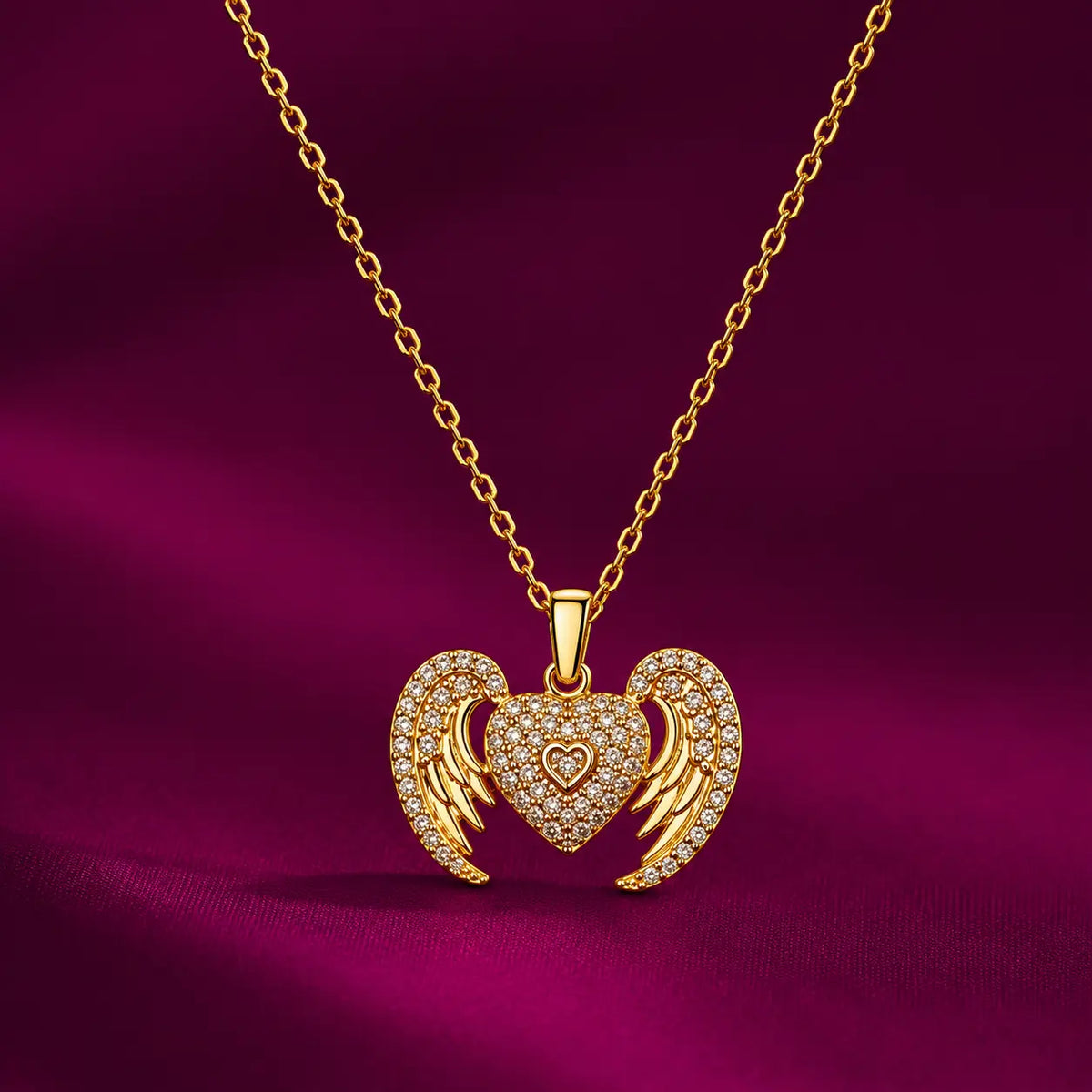 Gold-tone imitation jewellery necklace with a sparkling heart pendant and decorative wing design by Evah Jewels