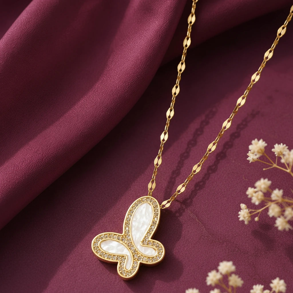 Gold-tone imitation jewellery necklace with a butterfly-shaped white pendant and sparkling stone detailing by Evah Jewels