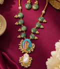 traditional green Meenakari necklace set with hand-painted Rajasthani woman portrait pendant, gold-tone floral motifs, pearl detailing and matching round earrings by Evah Jewels.