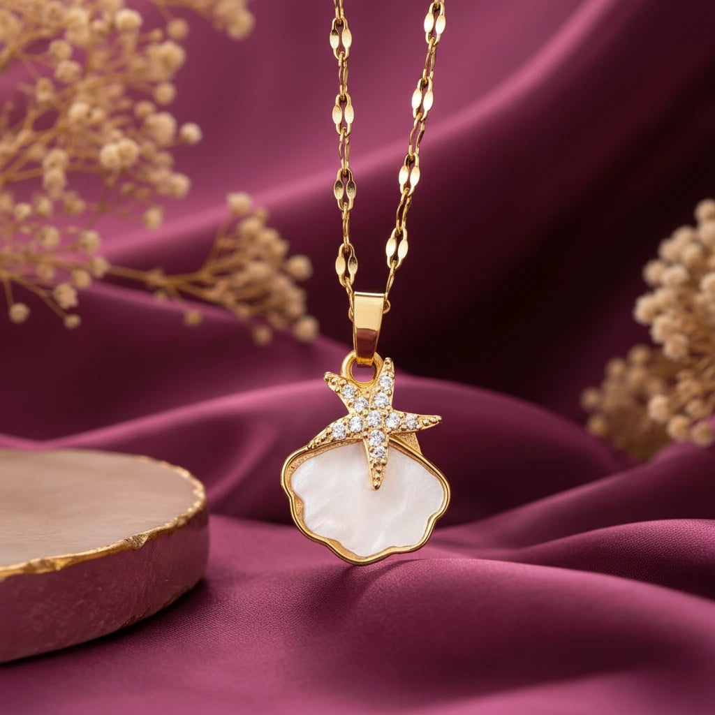 Gold-tone imitation jewellery necklace with a white shell-style pendant and sparkling star design by Evah Jewels