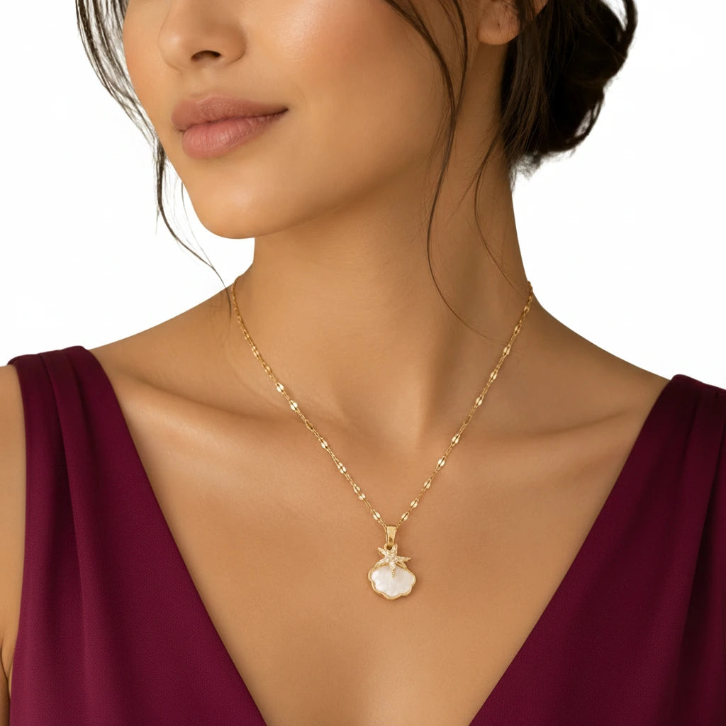 Gold-tone imitation jewellery necklace with a white shell-style pendant and sparkling star design by Evah Jewels